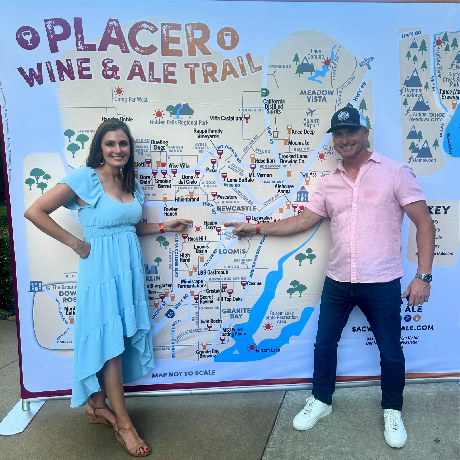 2 people standing infront of map of wine region